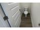 A powder room featuring new construction and a toilet. Doorway and base trim visible at 115 Arundel Dr, Archer Lodge, NC 27527