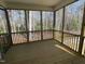 Spacious screened porch with wood flooring and views of the surrounding trees at 115 Arundel Dr, Archer Lodge, NC 27527