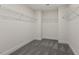 Walk-in closet with ample shelving and gray carpet flooring at 115 Arundel Dr, Archer Lodge, NC 27527