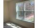 Bedroom features natural light from a large window with view of the wooded area at 115 Arundel Dr, Archer Lodge, NC 27527