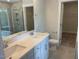 Bathroom with double vanity, tiled shower and walk-in closet access at 116 Arundel Dr, Archer Lodge, NC 27527