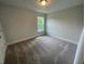 Cozy bedroom with neutral carpeting and a window providing natural light at 116 Arundel Dr, Archer Lodge, NC 27527