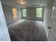 Large primary bedroom with tray ceiling, two windows, and neutral carpeting at 116 Arundel Dr, Archer Lodge, NC 27527
