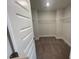 Spacious walk-in closet with white wire shelving and neutral carpeting at 116 Arundel Dr, Archer Lodge, NC 27527