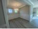 Elegant dining room featuring wainscoting, a modern chandelier, and ample natural light at 116 Arundel Dr, Archer Lodge, NC 27527