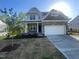 Charming two-story home featuring stone accents, landscaped yard, a two-car garage, and covered front porch at 116 Arundel Dr, Archer Lodge, NC 27527