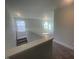 Upstairs hallway showing stairs, hallway, and views to the outside at 116 Arundel Dr, Archer Lodge, NC 27527