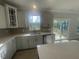 Bright kitchen with gray cabinets, stainless steel appliances, and sliding glass doors to outdoor space at 116 Arundel Dr, Archer Lodge, NC 27527