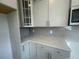 Modern kitchen with white countertops, gray backsplash, and stainless steel microwave at 116 Arundel Dr, Archer Lodge, NC 27527