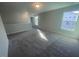Upstairs loft area with carpet flooring, windows, and access to additional rooms at 116 Arundel Dr, Archer Lodge, NC 27527
