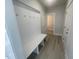 Mudroom with a built-in bench, storage hooks, and gray flooring at 116 Arundel Dr, Archer Lodge, NC 27527