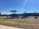 A colorful playground with multiple slides, climbing structures, and covered areas on a sunny day at 116 Arundel Dr, Archer Lodge, NC 27527