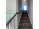Carpeted staircase with white railing leading to the upper level of the home at 116 Arundel Dr, Archer Lodge, NC 27527