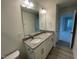 Bright bathroom with a granite countertop, dual sinks, and modern fixtures throughout at 118 Arundel Dr, Archer Lodge, NC 27527