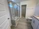 Contemporary bathroom with gray tiled walk-in shower, glass door, and tiled floors at 118 Arundel Dr, Archer Lodge, NC 27527