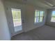 Light-filled bedroom with a balcony access and multiple windows offering lovely views at 118 Arundel Dr, Archer Lodge, NC 27527