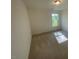 A bright bedroom featuring a window with natural light and plush carpet at 118 Arundel Dr, Archer Lodge, NC 27527