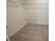 Carpeted walk-in closet featuring wire shelving and ample storage space at 118 Arundel Dr, Archer Lodge, NC 27527
