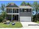 Two-story gray home with a two-car garage, stone accents, and a covered front porch at 118 Arundel Dr, Archer Lodge, NC 27527