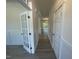 Bright hallway with beautiful vinyl floors, white trim and doors, and an abundance of natural light at 118 Arundel Dr, Archer Lodge, NC 27527