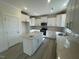 Bright kitchen with white cabinets, granite countertops, stainless appliances, and an island at 118 Arundel Dr, Archer Lodge, NC 27527