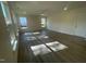 Sun-filled living room with grey vinyl floors, white walls, recessed lighting, ceiling fan, and natural light from large windows at 118 Arundel Dr, Archer Lodge, NC 27527