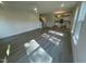 Open living room featuring light wood flooring, ceiling fan and view into the kitchen at 118 Arundel Dr, Archer Lodge, NC 27527