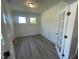 Office with two windows, gray wood floors, and white wainscoting at 118 Arundel Dr, Archer Lodge, NC 27527