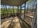 Relaxing screened porch with wood floors offers serene views of the surrounding trees at 118 Arundel Dr, Archer Lodge, NC 27527