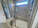 Modern glass enclosed shower with built-in bench and a window to let in natural light at 118 Arundel Dr, Archer Lodge, NC 27527