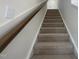 Carpeted stairway with white walls and stained wood handrail at 118 Arundel Dr, Archer Lodge, NC 27527