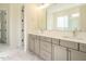 Bathroom with double vanity, large mirror, and neutral cabinetry at 1233 Azalea Garden Cir, Raleigh, NC 27603