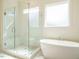 Modern bathroom featuring a glass-enclosed shower and a luxurious soaking tub at 1233 Azalea Garden Cir, Raleigh, NC 27603