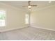 Bright bedroom with neutral paint, crown molding, carpeted floor and a modern ceiling fan at 1233 Azalea Garden Cir, Raleigh, NC 27603