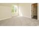 Bright bedroom features a large window and neutral carpet at 1233 Azalea Garden Cir, Raleigh, NC 27603