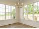Bright dining nook with large windows and modern light fixture at 1233 Azalea Garden Cir, Raleigh, NC 27603