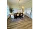 A dining area with a wooden table and chairs, a patterned rug, and wainscoting with warm paint above at 1233 Azalea Garden Cir, Raleigh, NC 27603