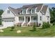 Charming two-story home with a covered porch, brick accents, and a well-manicured lawn at 1233 Azalea Garden Cir, Raleigh, NC 27603