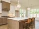 Spacious kitchen island with pendant lights, barstool seating, and modern countertops at 1233 Azalea Garden Cir, Raleigh, NC 27603