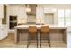 Modern kitchen island with seating, stainless steel appliances, and stylish pendant lighting at 1233 Azalea Garden Cir, Raleigh, NC 27603