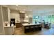 Bright open kitchen features an island with seating, pendant lighting, and stainless steel appliances at 1233 Azalea Garden Cir, Raleigh, NC 27603