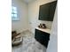 Well-lit laundry room with shaker cabinets, a countertop, and stylish geometric flooring at 1233 Azalea Garden Cir, Raleigh, NC 27603
