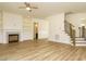 Open concept living room with fireplace, stairs, and access to multiple rooms at 1233 Azalea Garden Cir, Raleigh, NC 27603