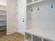 Well-organized mudroom area with built-in bench, hooks, and storage shelves at 1233 Azalea Garden Cir, Raleigh, NC 27603