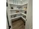 Walk-in pantry with white shelving that maximizes storage and provides organization at 1233 Azalea Garden Cir, Raleigh, NC 27603