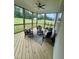 Screened-in porch offers outdoor seating and a ceiling fan at 1233 Azalea Garden Cir, Raleigh, NC 27603