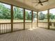 Relaxing screened porch with wood floors, ceiling fan, and views of the spacious backyard at 1233 Azalea Garden Cir, Raleigh, NC 27603