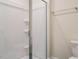 Bathroom shower with glass door and tiled walls, plus a toilet at 1233 Azalea Garden Cir, Raleigh, NC 27603
