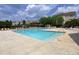 Community swimming pool with lounge chairs and surrounding landscaping at 2410 Huntscroft Ln # 203, Raleigh, NC 27617