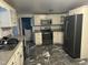 Modern kitchen with stainless steel appliances and marble-look flooring at 31 Strickland Rd, Smithfield, NC 27577